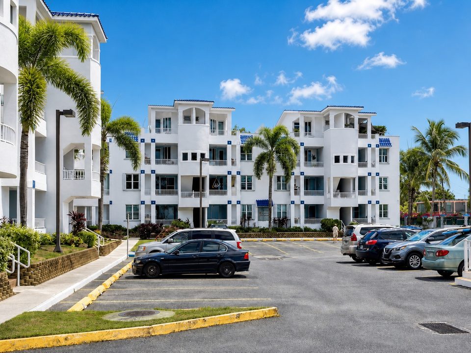 The gated parking area in front of the buildings